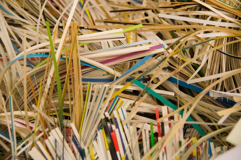 a pile of toothbrushes sitting on top of a pile of paper, by Richard Carline, process art, straw, endless books, laser cut textures, scrapyard