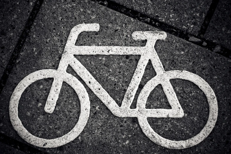 a white bicycle sign sitting on the side of a road, by Kurt Roesch, unsplash, icon black and white, texturized, detailed zoom photo, stock photo