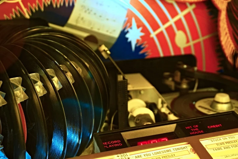 a collection of vinyl records sitting on top of a table, by Dicky Doyle, flickr, kinetic art, low saturated red and blue light, 7 0 s hi fi system, closeup - view, pi-slices and kidmograph