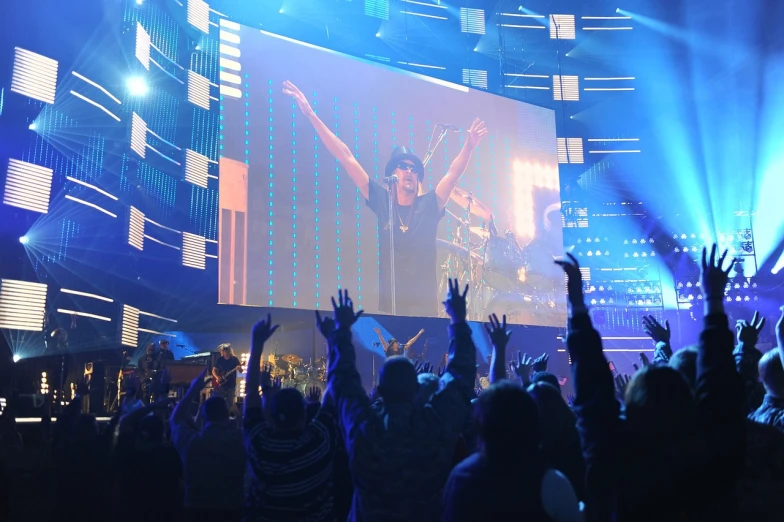 a group of people that are standing in front of a screen, live concert, triumphant fate, e3, watch photo