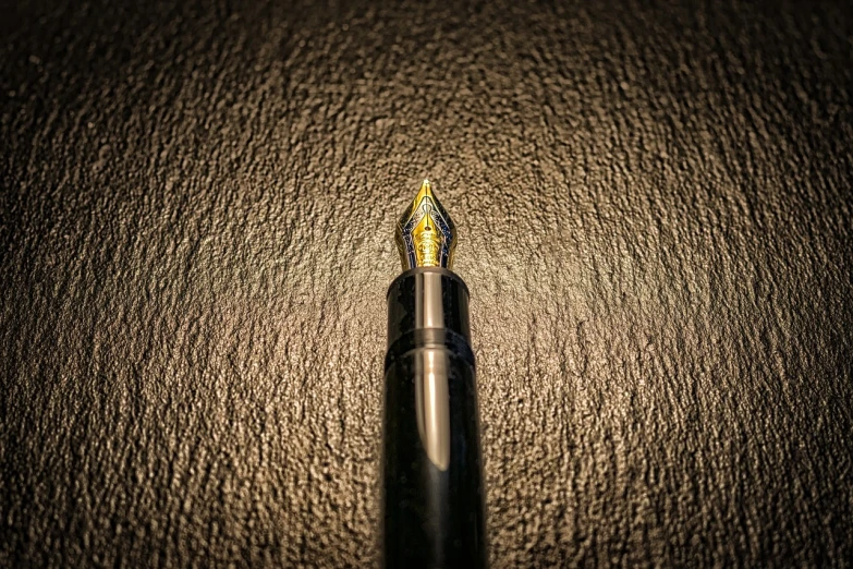 a fountain pen sitting on top of a table, a stipple, minimalism, highly detailed product photo, supersharp photo