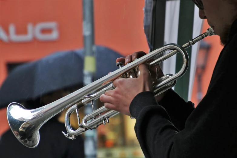 a close up of a person playing a trumpet, a picture, by Erwin Bowien, pexels, photorealism, street - level, live performance, ((oversaturated)), band