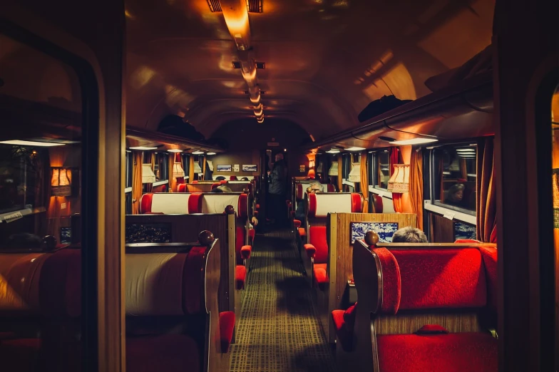 the inside of a train car with red seats, a portrait, by Etienne Delessert, shutterstock, dimly lit cozy tavern, retro effect, evening at dusk, set photo