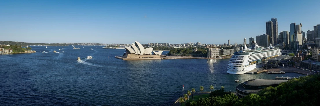 a cruise ship in the water with a city in the background, inspired by Sydney Carline, shutterstock, sydney opera house, sunny morning light, gigapixel photo, overview