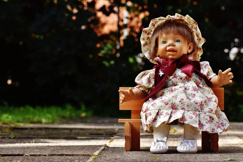a doll sitting on top of a wooden bench, trending on pixabay, realism, charming smile, ornately dressed, toddler, on sidewalk