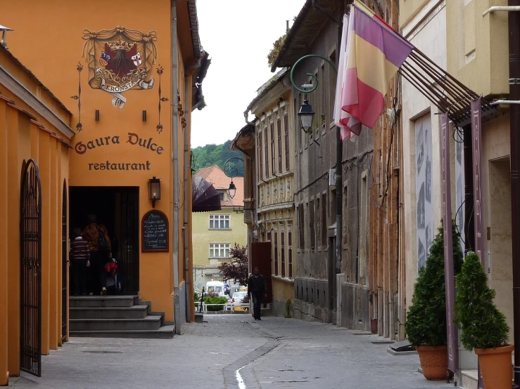 a narrow street in an old european city, inspired by Slava Raškaj, flickr, transylvania, restaurant in background, sakuga, opposite the lift-shaft