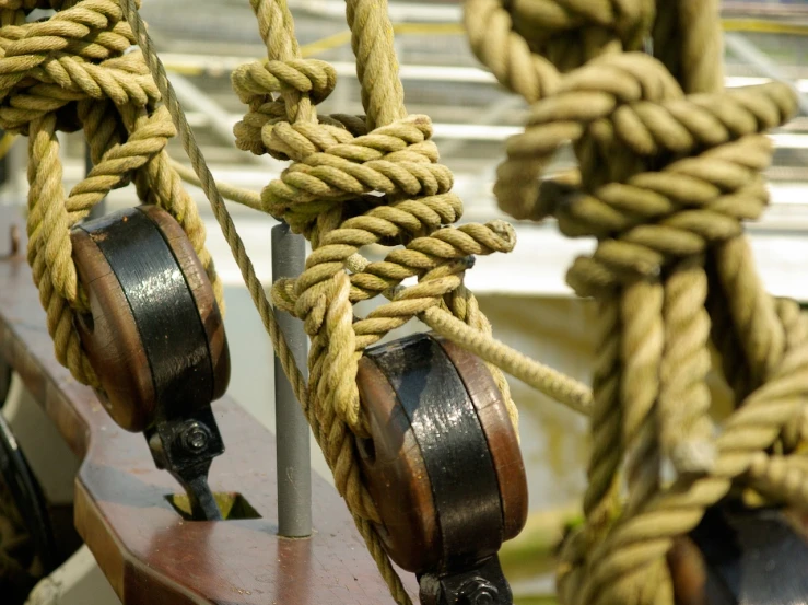 a close up of ropes and pulleys on a boat, a portrait, by Richard Carline, flickr, renaissance, looping, accurate and detailed, training, varnished