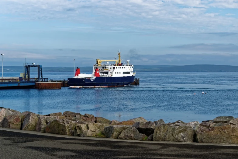 a large boat sitting on top of a body of water, by John Murdoch, flickr, the harbour at stromness orkney, near a jetty, side view profile, round about to start