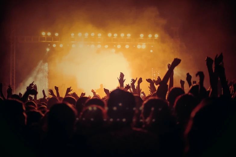 a crowd of people at a concert with their hands in the air, by Matt Cavotta, figuration libre, mikko lagerstedt, thick dust and red tones, billboard image, bottom angle