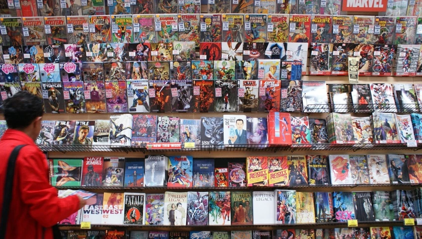 a man standing in front of a wall of comics, pexels, istock, shelves full, marvel poster, seen from above