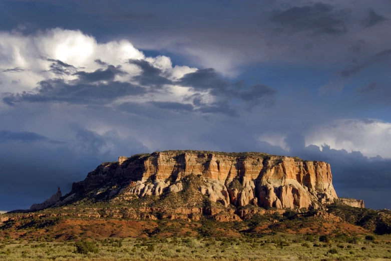 a horse standing in front of a mountain under a cloudy sky, by Nancy Carline, beautiful new mexico landscape, vertical wallpaper, rock plateau, panoramic