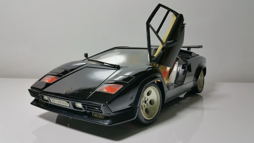 a close up of a toy car on a table, a picture, by Kentaro Miura, tumblr, hyperrealism, pantera ((countach)), black lacquer, full body close-up shot, 1 / 1 6 th scale