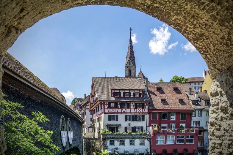 a bridge over a river with a building in the background, a picture, by Karl Stauffer-Bern, pexels, romanesque, black forest, looking through a portal, houses and buildings, berkerk