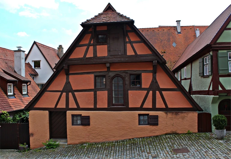 a house in the middle of a cobblestone street, by Juergen von Huendeberg, flickr, renaissance, red trusses, in dunwall, durer, well contoured smooth fair walls