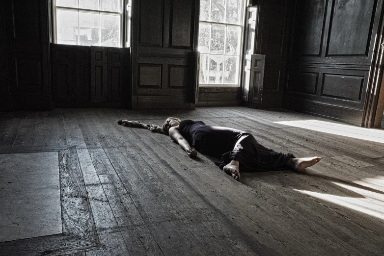 a man laying on the floor in an empty room, a photo, inspired by Artemisia Gentileschi, flickr, vanitas, dancer, kiki smith, in a sunbeam, performing to dead soldiers