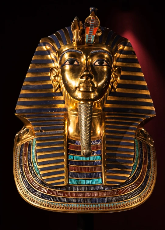 a golden mask sitting on top of a table, egyptian art, by Scott M. Fischer, shutterstock, history channel, cartier, award winning”, portrait of tall