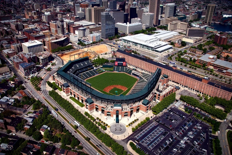 an aerial view of a baseball stadium in a city, by Paul Emmert, tourist photo, orange line, big!!!!!!!!!!!!, lots of building