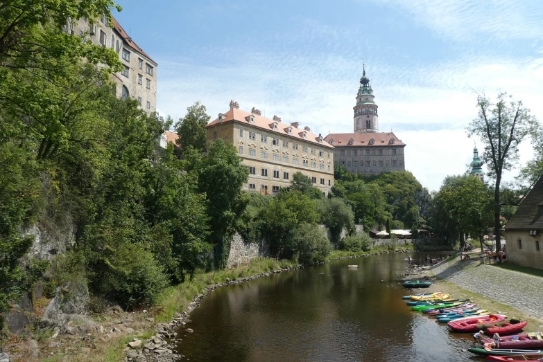 a group of boats sitting on top of a river, by Karel Štěch, flickr, palace on top of the hill, loreta lux, seen from the side, summer day