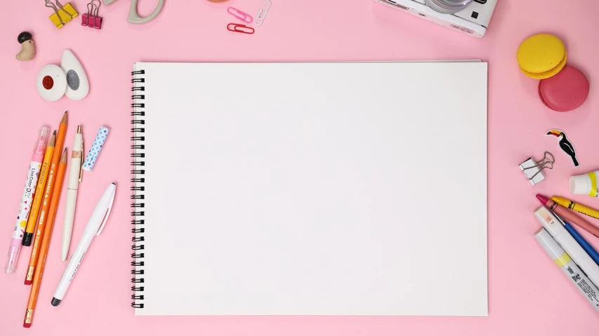 a notebook surrounded by school supplies on a pink surface, a drawing, visually crisp & clear, unfinished canvas, product introduction photo, background image