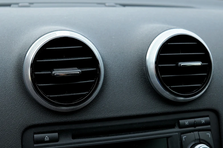 a close up of two air vents in a car, les automatistes, all enclosed in a circle, high res photo, really realistic, very sparse detail