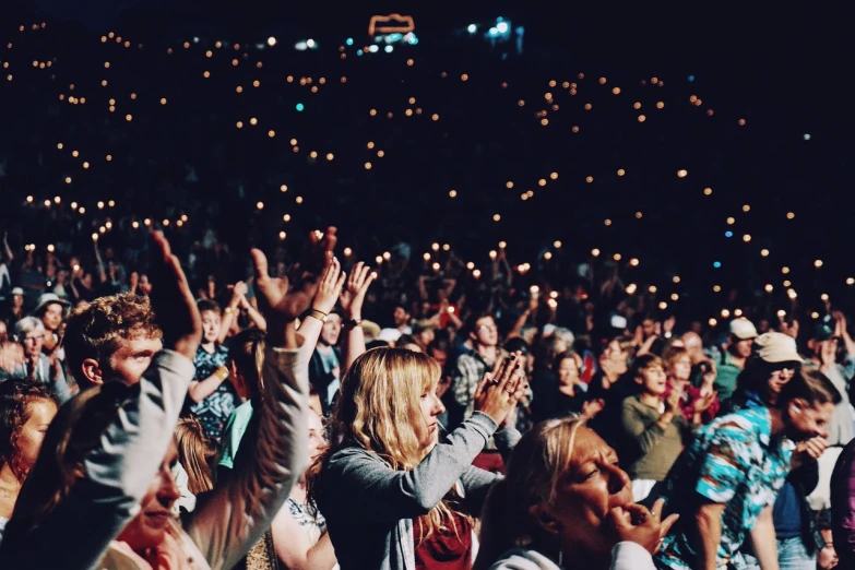 a crowd of people with their hands in the air, pexels, tabernacle deep focus, photo taken at night, ladies, listening to godly music