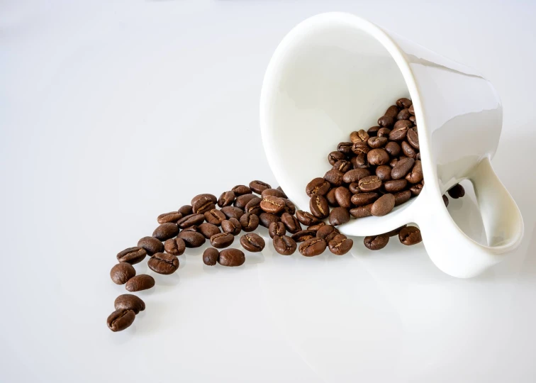 a cup filled with coffee beans spilling out of it, minimalism, vomit, high quality product photo