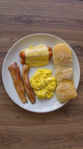 a white plate topped with bacon, eggs, and a hot dog, by Sebastian Spreng, flickr, bauhaus, children's, butter, breakfast buffet, jake the dog