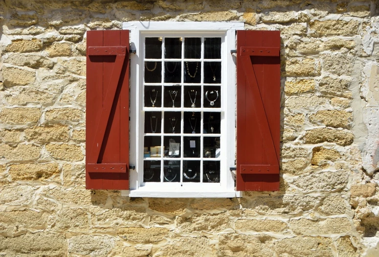 a window with red shutters on a stone wall, by Edward Corbett, shutterstock, folk art, jewelry display, 1 8 th century style, 2 0 1 0 photo, jail