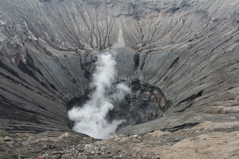 a large crater with steam coming out of it, sumatraism, volcanic skeleton, close up shot from the top, inside view, front side view