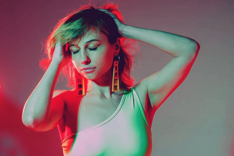 a woman posing with her hands on her head, a colorized photo, inspired by Elsa Bleda, tumblr, pop art, side portrait of imogen poots, red neon details, huge earrings, electric woman