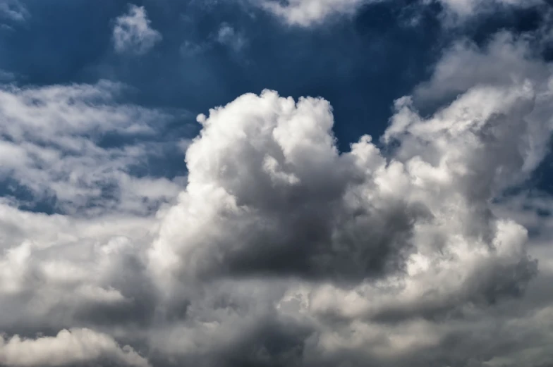 a plane flying through a cloudy blue sky, a portrait, by Hans Schwarz, big cumulonimbus clouds, hdr detail, detailed zoom photo, in forcasted sky