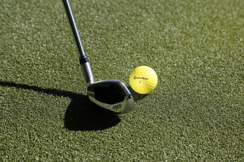 a golf ball sitting next to a golf club, by Jason Felix, afp, a green, combine, off putting