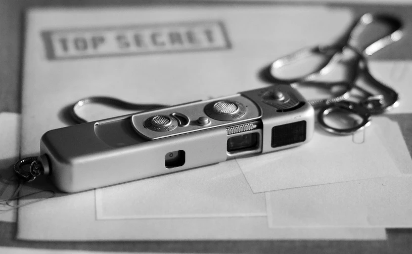 a pair of scissors sitting on top of a piece of paper, a black and white photo, inspired by Henri Cartier-Bresson, serial art, home album pocket camera photo, top secret, close up shot of an amulet, secret agents
