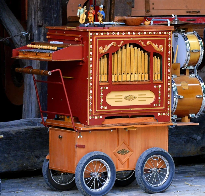 a musical instrument sitting on top of a cart, inspired by Bryan Organ, flickr, switzerland, caravan, style of vogelsang, catalog photo