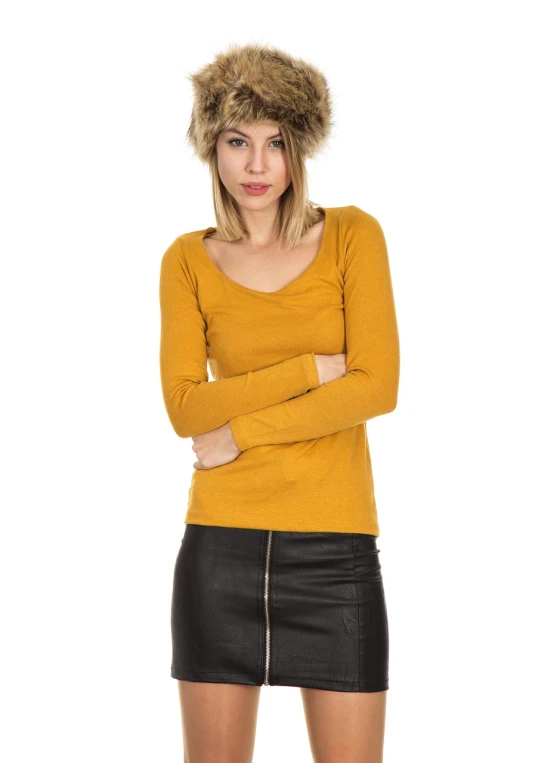 a woman wearing a furry hat posing for a picture, inspired by Adrienn Henczné Deák, minimalism, long sleeve, mustard, small breasts, slim