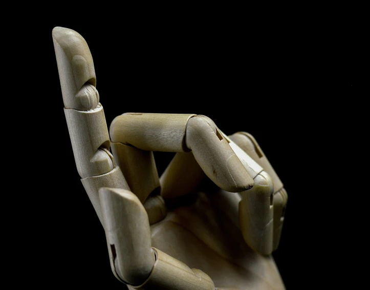 a wooden hand making a peace sign with it's fingers, a macro photograph, by Alexander Robertson, robotic prosthetic arm, bamboo, low key, folded