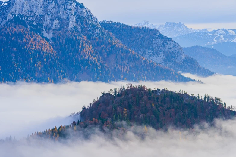 a plane flying over a mountain covered in fog, a picture, by Franz Hegi, shutterstock, romanticism, autumn foliage in the foreground, germany. wide shot, loots of clouds, zig-zags. mountains