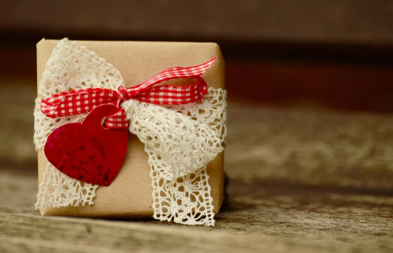 a gift wrapped in brown paper with a red heart on it, a picture, lace, featured, 4k post, quaint