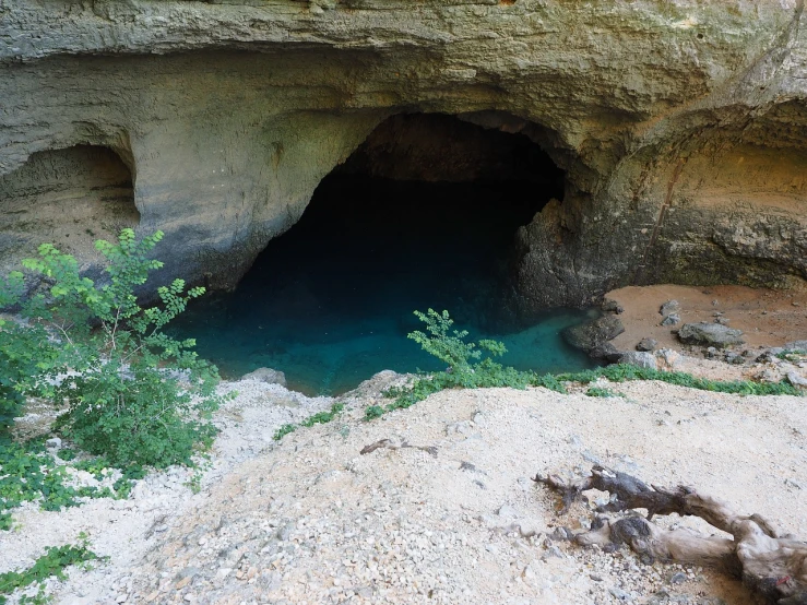 a cave with a body of water inside of it, flickr, les nabis, tx, the see horse valley, cobalt coloration, fonte à la cire perdue