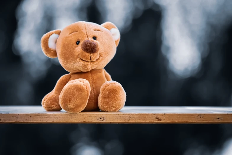 a brown teddy bear sitting on top of a wooden table, a picture, by Niko Henrichon, shutterstock, sitting on a store shelf, soft happy smile, stock photo, excellent contrast