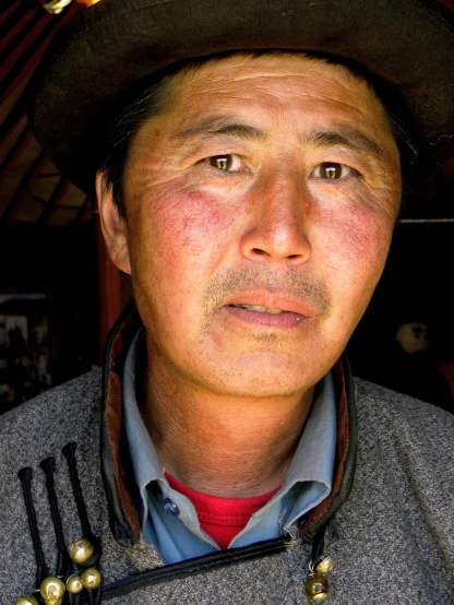 a close up of a person wearing a hat, a portrait, flickr, shin hanga, omar shanti himalaya tibet, lean man with light tan skin, dad, red cheeks