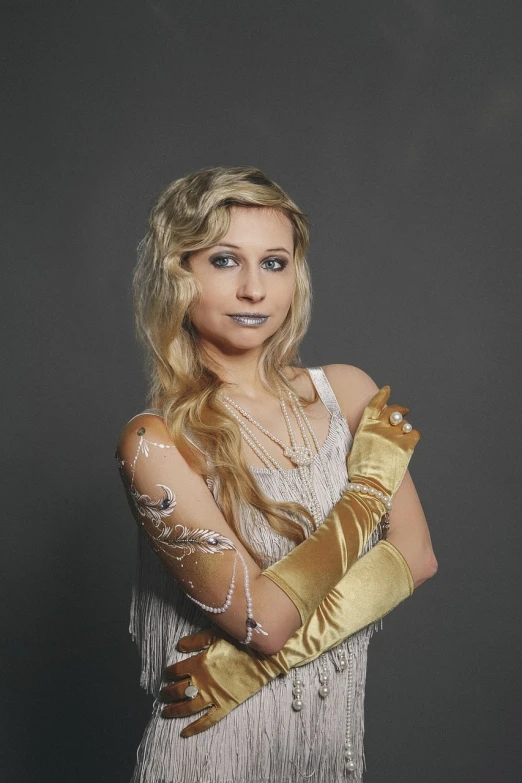 a woman in a dress and gloves posing for a picture, a portrait, inspired by Aimé Barraud, art nouveau, golden gloves, with long blond hair, professional portrait photo, fingerless gloves