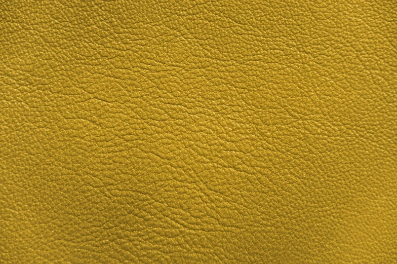 a close up of a yellow leather surface, a stock photo, high detail product photo, gold color scheme, 35 mm product photo”, zido