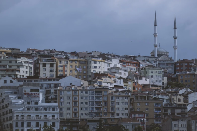 a city filled with lots of tall buildings, hurufiyya, 7 0 mm photo, old town, overcast!!! cinematic focus, in the hillside