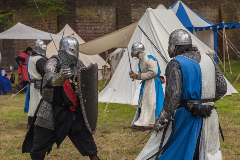 a couple of men that are standing in the grass, by Simon de Vlieger, shutterstock, renaissance, blue and ice silver color armor, tickle fight in the death tent, tournament, taken in 2 0 2 0