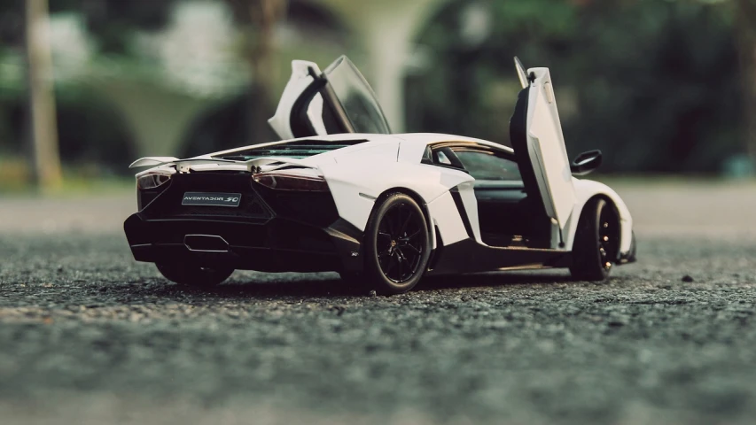 a close up of a toy car with open doors, by Niko Henrichon, unsplash, photorealism, lamborghini aventador photoshoot, “wide shot, hq 4k phone wallpaper, micro detail 4k