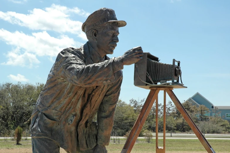 a statue of a man with a camera on a tripod, a statue, inspired by Dorothea Lange, visual art, right side profile, large format camera, miner kilbourne kellogg, with high detail