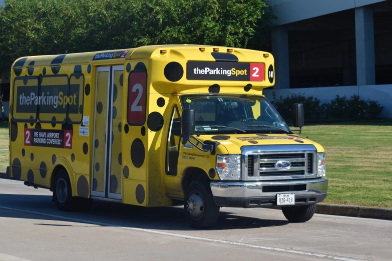 a yellow school bus driving down a street, the cytoplasm”, parking lot, yellow and black color scheme, tx