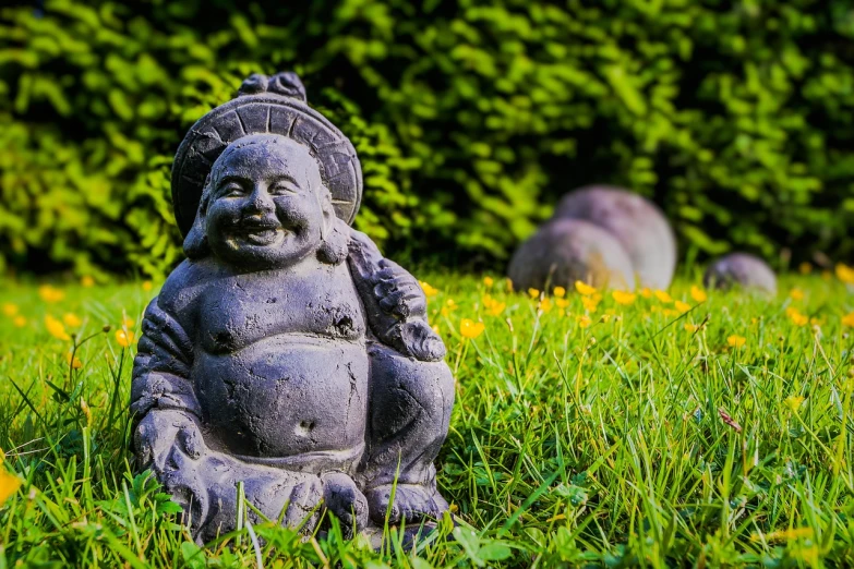 a statue sitting on top of a lush green field, inspired by Kaigetsudō Ando, unsplash, concrete art, happy wise. he has bouncy belly, he is smiling, gnomon, high quality image”