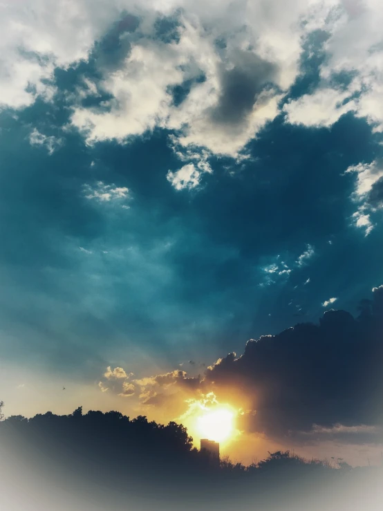 a large jetliner flying through a cloudy sky, a picture, unsplash, romanticism, the sun. beautiful, dramatic clouds cyan atmosphere, fire from sky, photo taken with an iphone